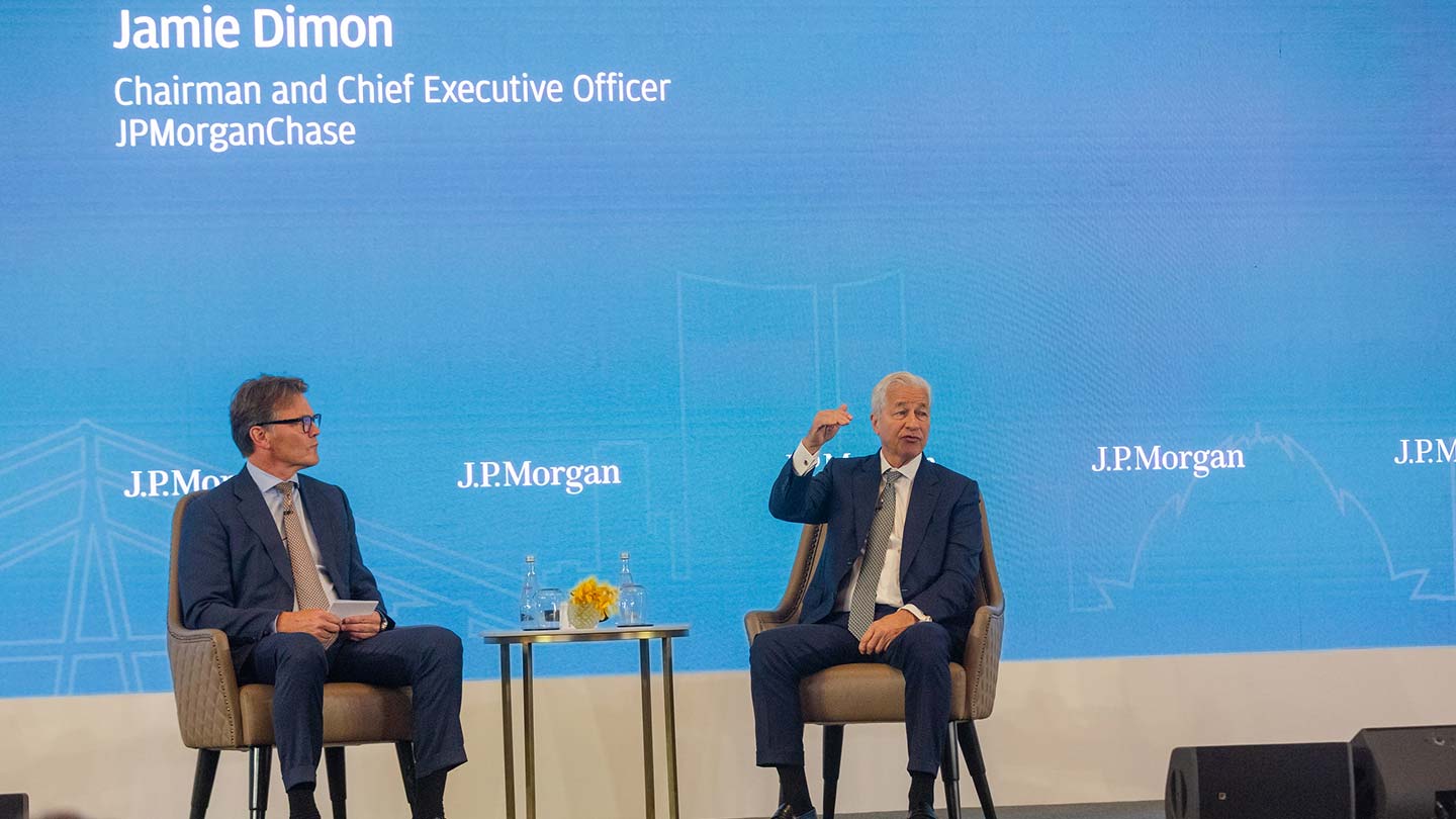 Three men lighting a diya lamp