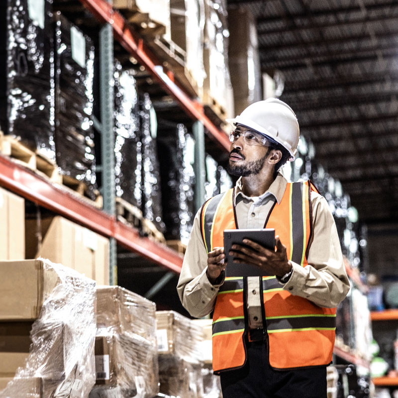 Man wearing safety vest looking at stock